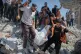 Palestinian civil defence crews carry a body from the rubble of a collapsed building that housed displaced Palestinians and was heavily damaged by Israel's genocidal onslaught of the strip, in Gaza City, September 16, 2026