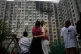Locals watch as firefighters work after a Russian drone attack struck a residential building in Kyiv, September 1, 2026