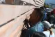 Relatives of crew members of the boat Maria Candelaria peer through a fence outside a police facility in Manta, Ecuador, September 7, 2026