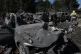 Rescue workers inspect charred cars at the site of Israeli airstrike southern Lebanese village of Kfar Rumman, September 7, 2026