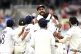 India’s Virat Kohli (top) celebrates taking England’s Jo