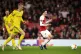 Arsenal's Mesut Ozil (right) watches the ball roll out of hi