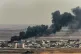 Smoke rises from the Syrian town of Ras al-Ayn after Turkish