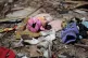 A child’s shoe and clothes are left at a site of Saudi-led