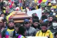 Mourning crowds carry the coffin of indigenous leader Inocen