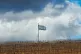 n Israeli flag waves on the top of a hill near the so-called