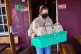 A volunteer prepares free packed lunch bags for local kids d