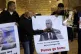 A Palestinian man beats a picture of US Vice-President Mike 