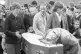 Mourners file past the coffin of Father Hugh Mullan, at Corp