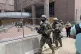 Armed members of the Minnesota National Guard are shown leav