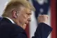 President Donald Trump pumps his fist as he finishes speakin
