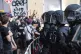 Police officers hold protesters back from stopping an evicti