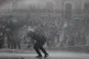 Police water cannon demonstrators at the Plaza de Santo Domi