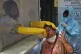 A health worker collects a nasal swab sample to test for Cov