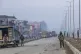 Indian paramilitary soldiers stand guard on a road leading t