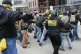 Members of the Proud Boys fight with a counter protester dur