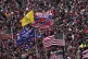 People listen as President Donald Trump speaks during a rall