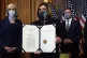 US House Speaker Nancy Pelosi displays the signed article of