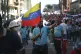 A government supporter holds a Venezuelan national flag duri