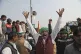 Farmers shout slogans as they arrive at the site of an ongoi