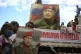 Children hold a portrait of the late President Hugo Chavez d