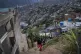 A woman with her son climb up the hill in the El Quilombo ne