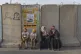 Palestinians wait to cross the Qalandia checkpoint between t