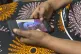 Anifa holds her phone displaying a photo of former World Hea