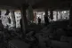 Palestinians inspect the damage of a house was hit in early 