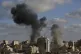 An Israeli air strike hits a building in Gaza City earlier t