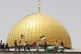 Palestinians wave national and Hamas flags in front of the D