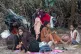 Ethnic Rohingya people rest on a beach after their boat was 