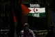 A supporter waves a flag reading 