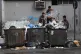 Boys search garbage containers for valuables and for metal c