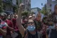 Demonstrators carry pictures of Nizar Banat, an outspoken cr