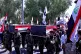 Popular Mobilisation Forces fighters carry flag-draped mock 
