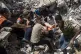 alestinian rescue a survivor from under the rubble of a dest
