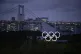 The Olympic rings are illuminated at dusk during the 2020 Su