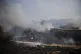 Fields burn following a hit by a rocket fired from Lebanon i
