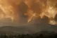 Smoke spreads over Parnitha mountain during a wildfire in th