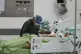 Medical staff assists with oxygen supply to a COVID-19 patie
