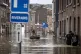  a man rows a boat down a residential street after flooding 