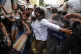 Riot police detain demonstrators during a gathering to celeb