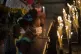 A girl kneels in prayer before candles at Our Lady of Cobre 