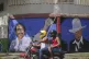 Motorcyclists pass a poster depicting Nicaraguan leader Dani
