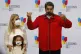 Accompanied by his granddaughter and first lady Cilia Flores