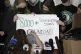 Starbucks employees alter a campaign sign during a press con