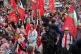 Palestinian activists wave their party's red flags as they r