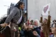 Mosque shooting survivor Abdul Aziz is held aloft as he than