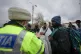 A police officer talks to refugees fleeing the conflict from